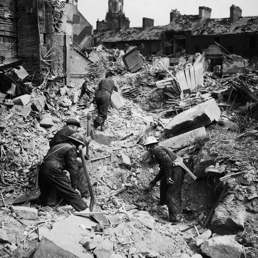 After an errant German air raid on May 7, 1941, rescue workers dig through the rubble of Egligton Street near Shankill Road in the city of Belfast.