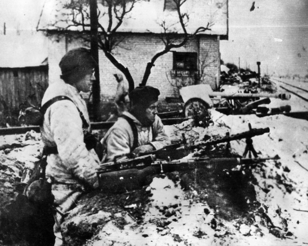 On the edge of a Russian village, German soldiers wait for the inevitable enemy approach.