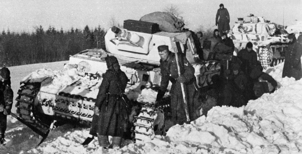 Picks and shovels are used to clear snow from the tracks of a buried German tank. Conditions around Cherkassy shifted from near blizzard-like to a muddy mess—all serving to delay troop movements.