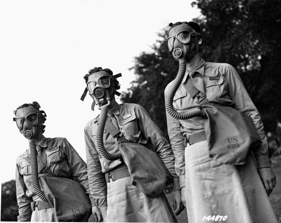 WACs don gas masks during their basic training. Lena Derriecott learned the rudimentary functions and procedures of being a soldier.