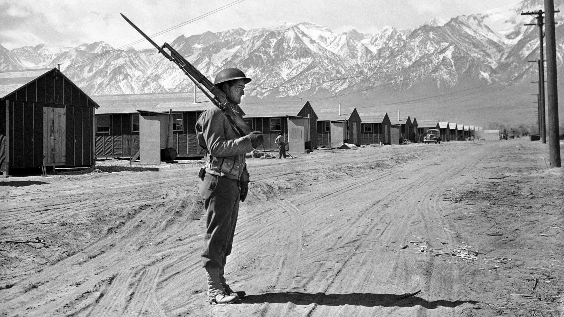  A U.S. soldier stands guard in 1943 at the internment camp for Japanese Americans located at Manzanar, California. 