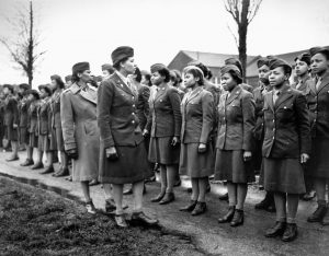 Major Charity Adams and Captain Abbie Campbell inspect the ranks of the 6888th Central Postal Battalion in England. The WACs of the battalion were proud of their service record in Europe.