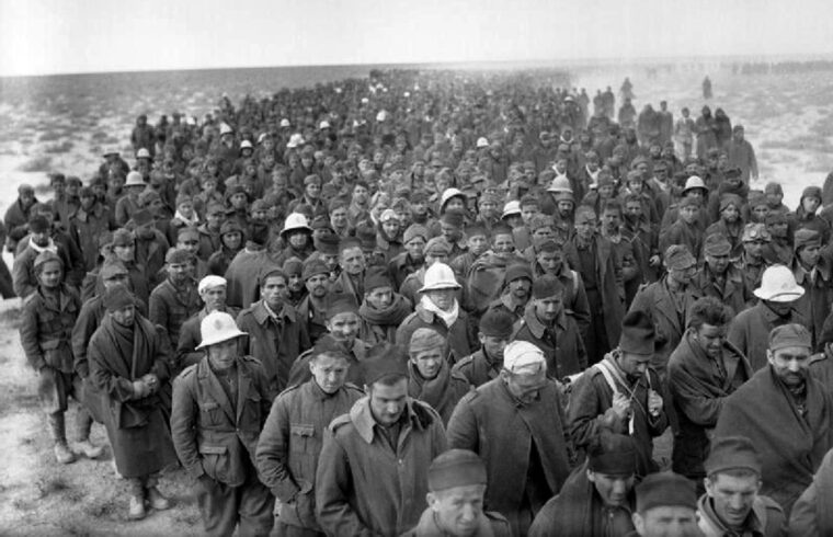 Some of the thousands of Italian prisoners captured during Operation Compass in North Africa in 1941 are headed toward a holding area for eventual transport to prison camps. 