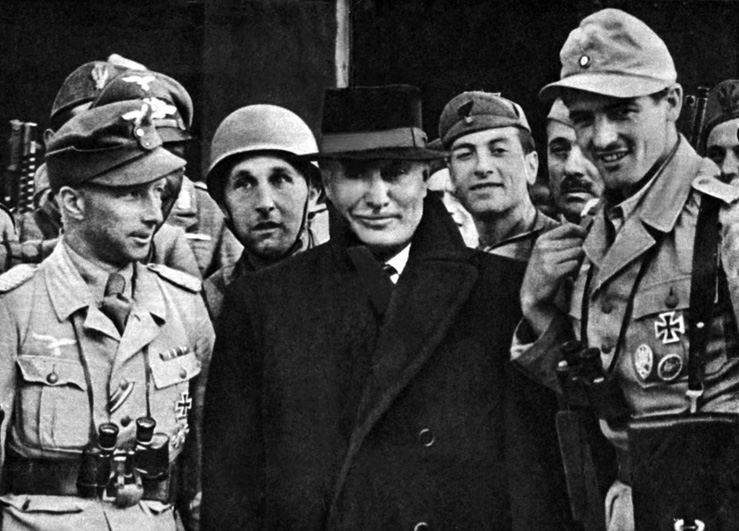 Mussolini and his German rescuers leave the  Campo Imperatore Hotel on the Gran Sasso Massif in the Apennine Mountains after the former  dictator had been held under guard there in 1943.