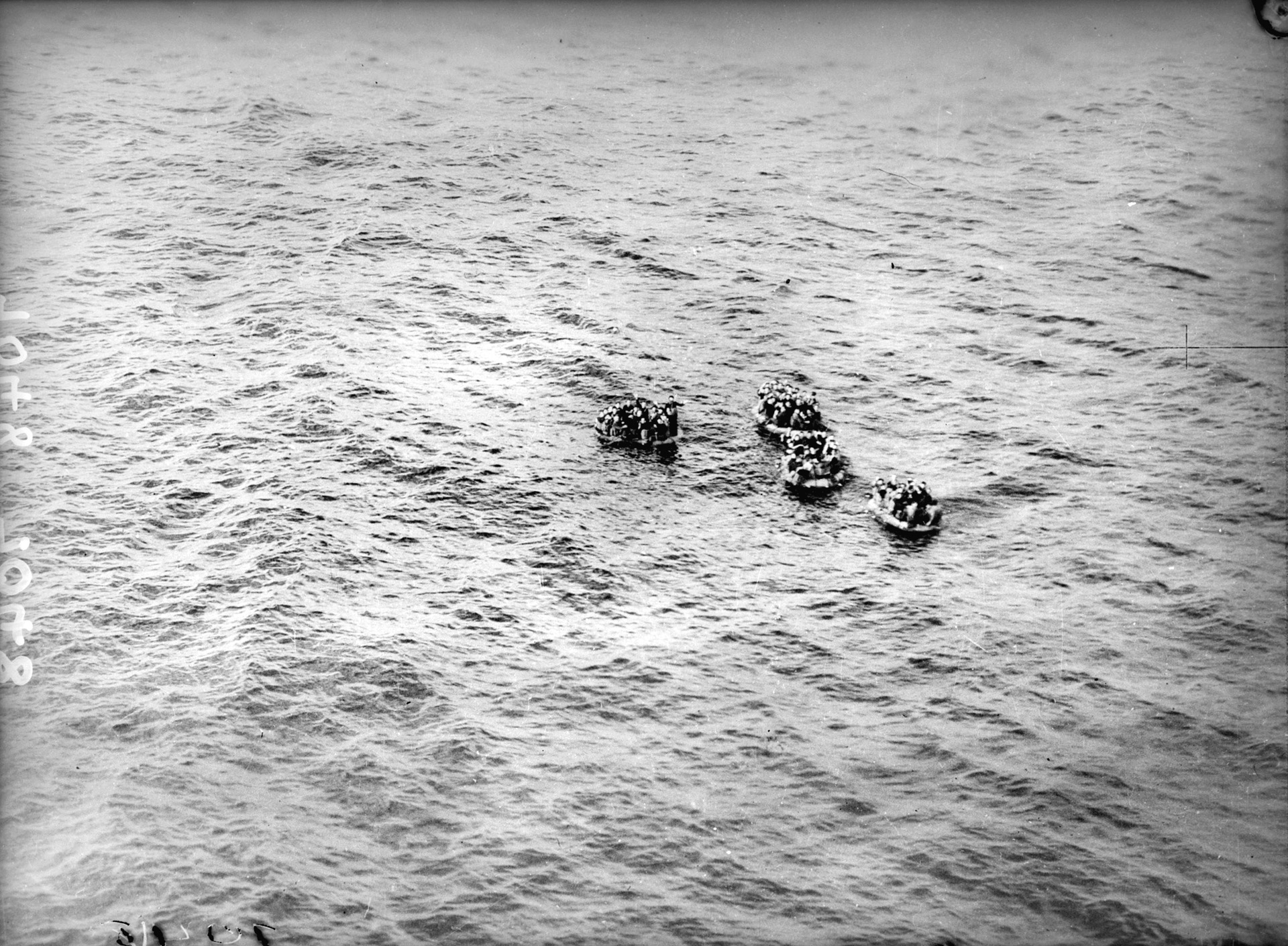 Italian sailors, survivors of the Battle of Cape Matapan, float in the Mediterranean Sea. The position of the survivors was relayed to Italian authorities, and a hospital ship was directed toward the  location to rescue them.