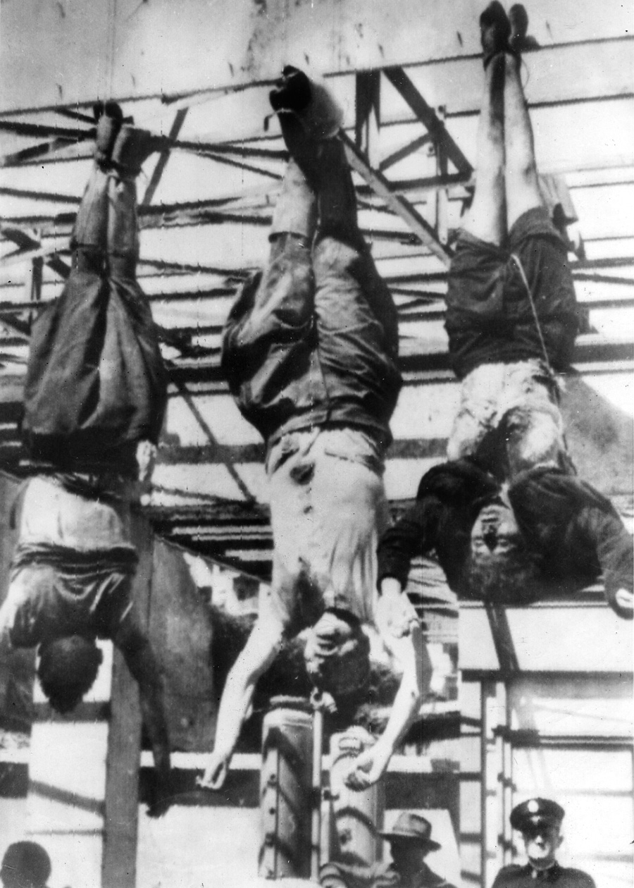 The mutilated bodies of Mussolini and his  mistress Claretta Petacci are strung up along with those of other Fascists after their execution. 