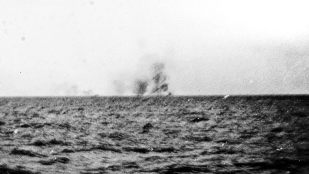 This photo shows the pall of smoke rising  from the grave of the British battlecruiser Hood, which broke up and swiftly sank. 