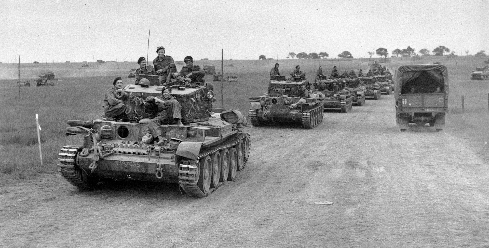 Rearmed and refueld, a long line of British Cromwell tanks prepare to move out along a dirt road near Caen. Stubborn German resistance at Caen prevented the British from taking the city until July 20, by which time the crossroads city had lost its strategic value.