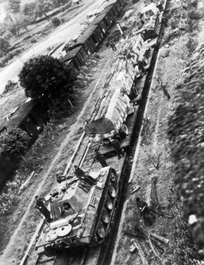 A German train hauls tanks and service vehicles of the 1st SS Panzer Regiment to the front near Caen, July 1944. The Germans, with two panzer corps in the area, were especially strong.