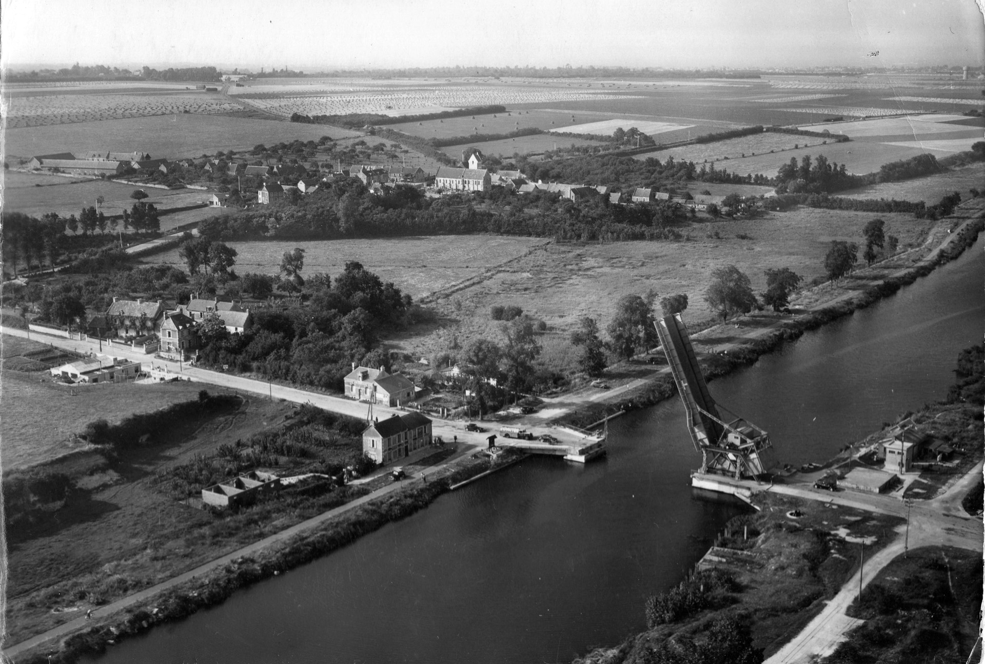This post-war photograph shows the village of Benouville at left, Cafe Gondree next to the canal, and the drawbridge over the Caen Canal. After they captured the bridge, the British transformed the cafe into an aid station. 