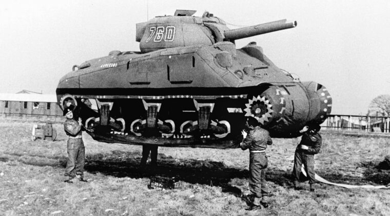 British soldiers hoist a lightweight, inflatable dummy Sherman tank. Soldiers in the U.S. Army’s top-secret “23rd Headquarters Special Troops” unit, also known as the “Ghost Army,” were detailed to deceive the Germans about Allied troop build-ups and positioning and draw the enemy away from the actual Allied intentions.