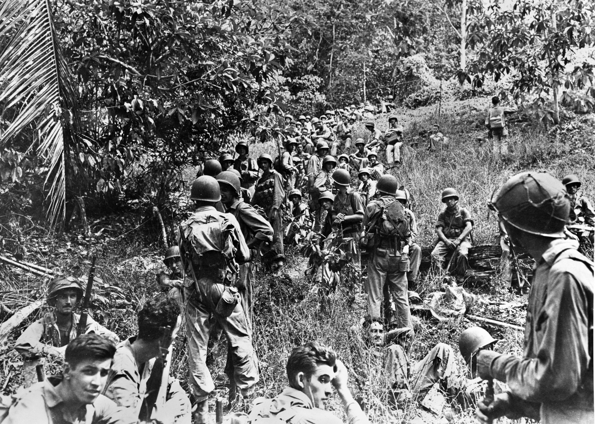 After hitting the invasion beaches and moving inland, U.S. Marines take a brief rest on Guadalcanal in the Solomons. The Guadalcanal campaign would be the Marines’ first and longest major battle of the war—lasting six months, from August 7, 1942 until February 9, 1943. This unit has yet to be issued the distinctive splotched camouflage helmet covers. 