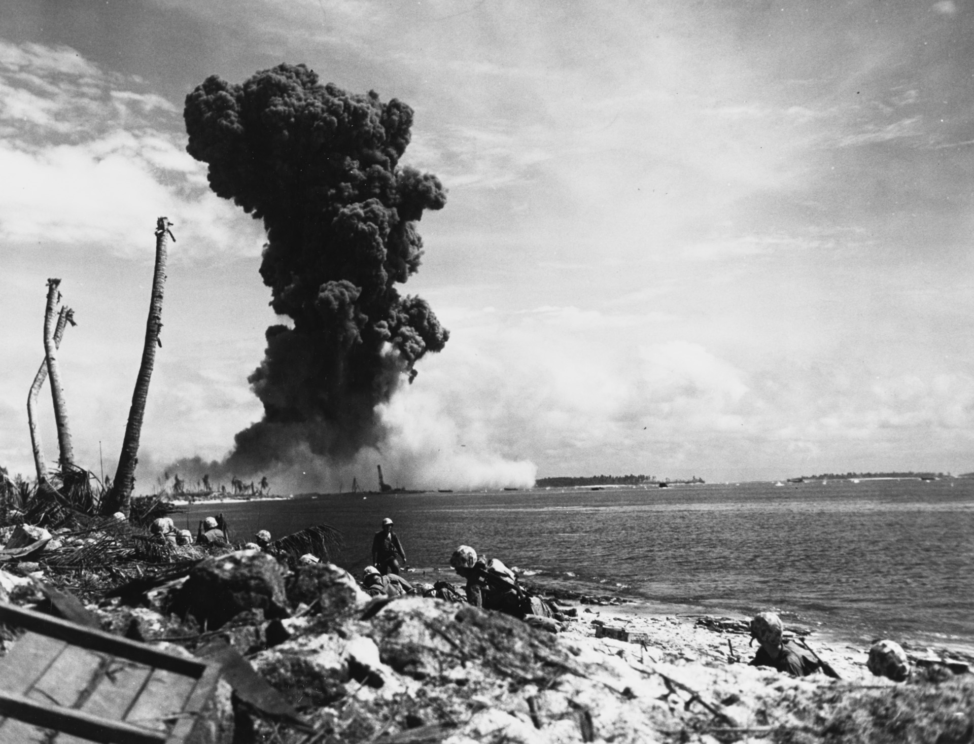A huge explosion shakes the beach at Kwajalein during the combined Marine-Army November 1943 invasion of the Gilbert and Marshall Islands. Kwajalein, Roi-Namur, and Eniwetok were especially well fortified by the Japanese.