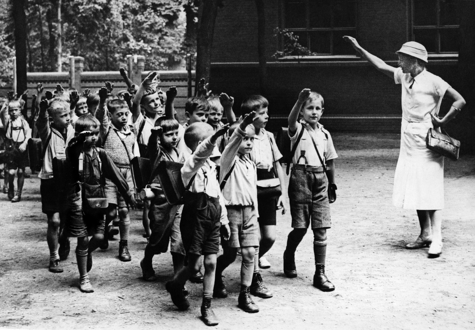 A group of boys, believed to be products of the Lebensborn program, give the Nazi salute while on an outing. Richard Hildebrandt, head of the prgram was executed in 1952.