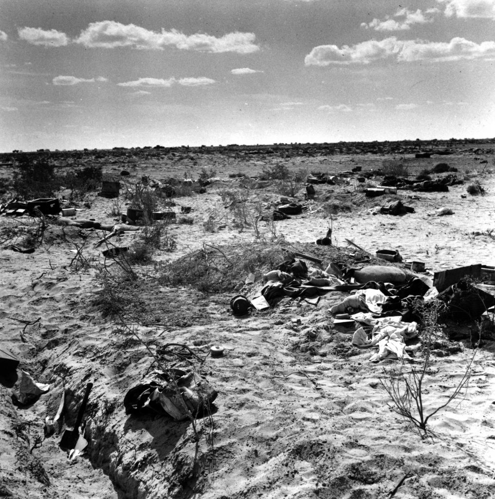 Dead Germans and their personal effects lie strewn across a scarred landscape following the capture of their position by British troops. 