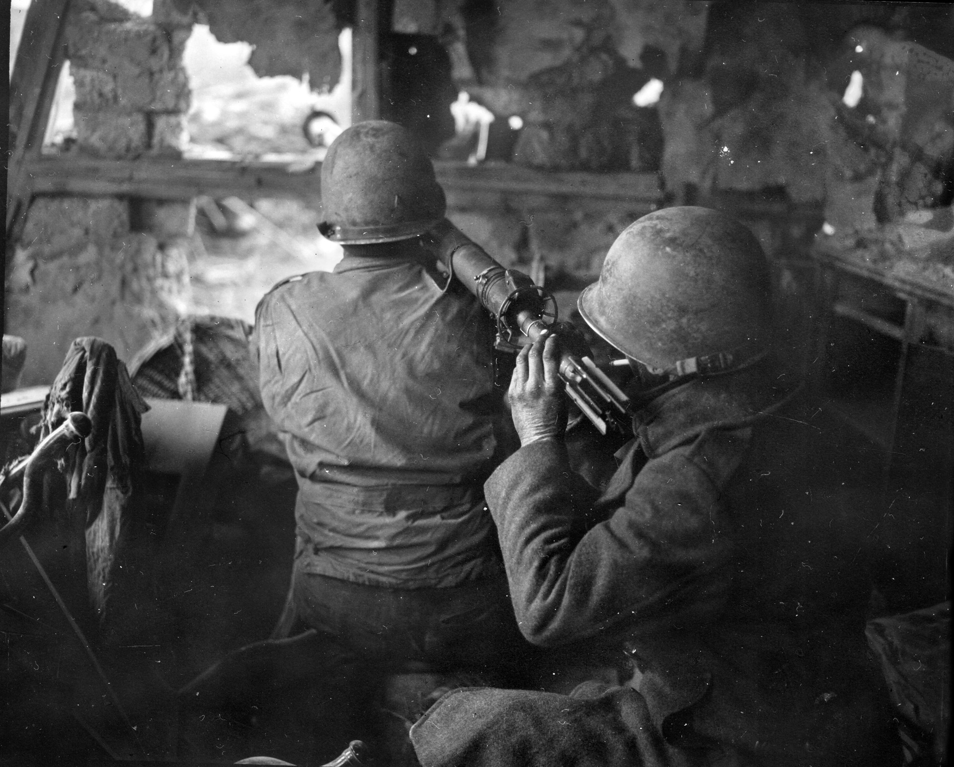 From their position inside a ruined house, two solders from the 4th Infantry Division’s 22nd Infantry Regiment fire on a German tank with a 3.5-inch rocket launcher, commonly called a “bazooka,” during the Battle of the Bulge, December 1944.