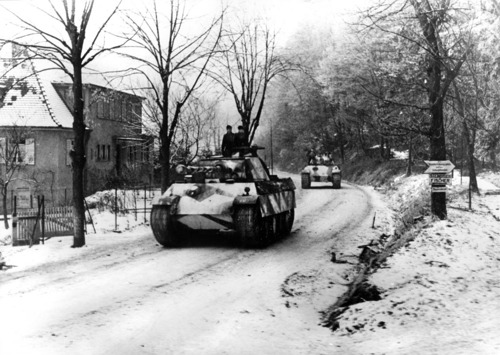 German PzKpfw. V Panther medium tanks, mounting high-velocity 75 mm cannon, advance along a snow-covered road in the Hagenau Forest and the lower Vosges Mountains of France on January 31, 1945.  