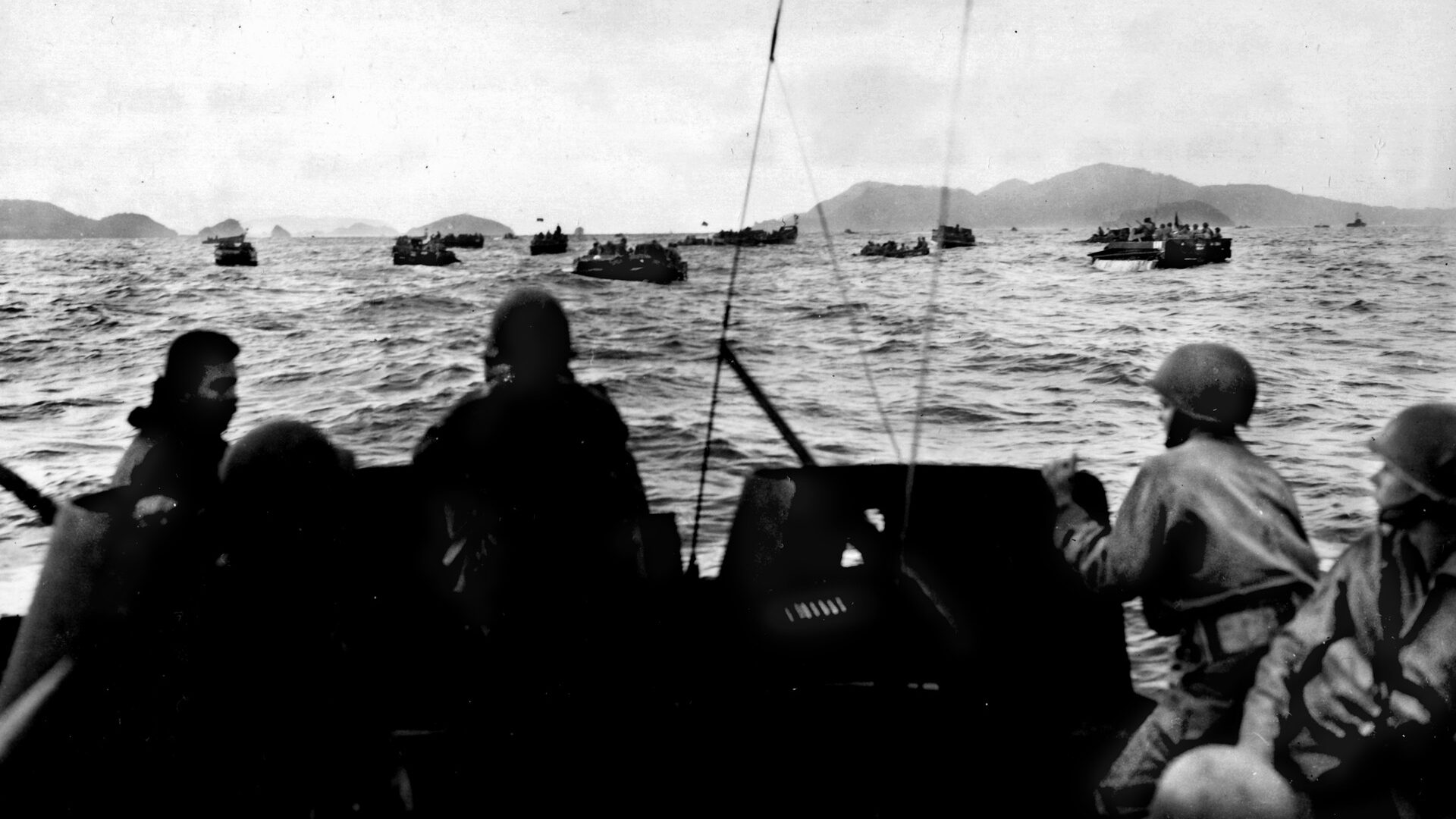 Amphibious tractors carrying the 1st Battalion, 305th Infantry, 77th Division, head for the beaches of Zamami Shima, March 26, 1945.