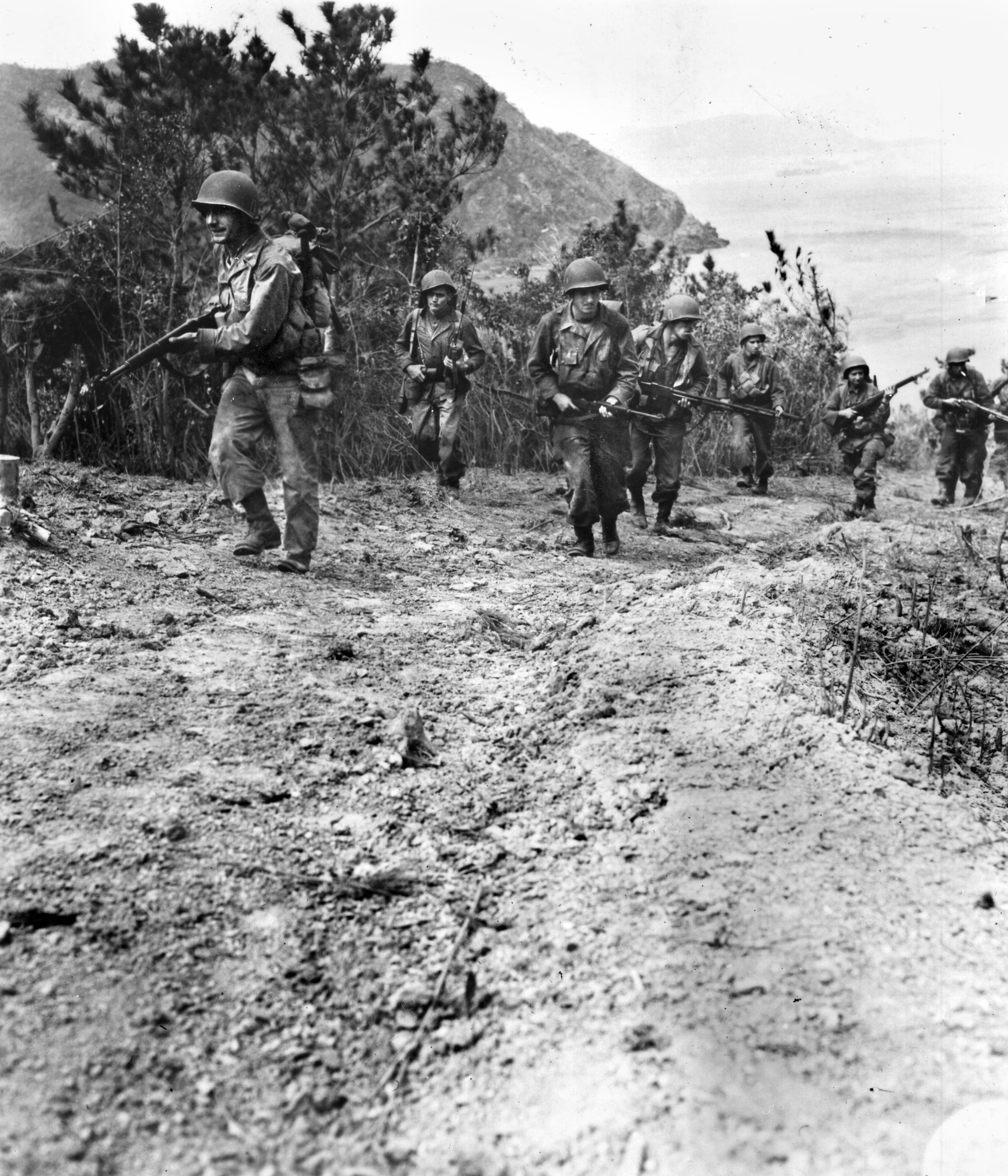 An advance patrol of the 77th Infantry Division moves cautiously up a trail on Takashiki Shima, scouting an advance route for the main body that later overran the island.