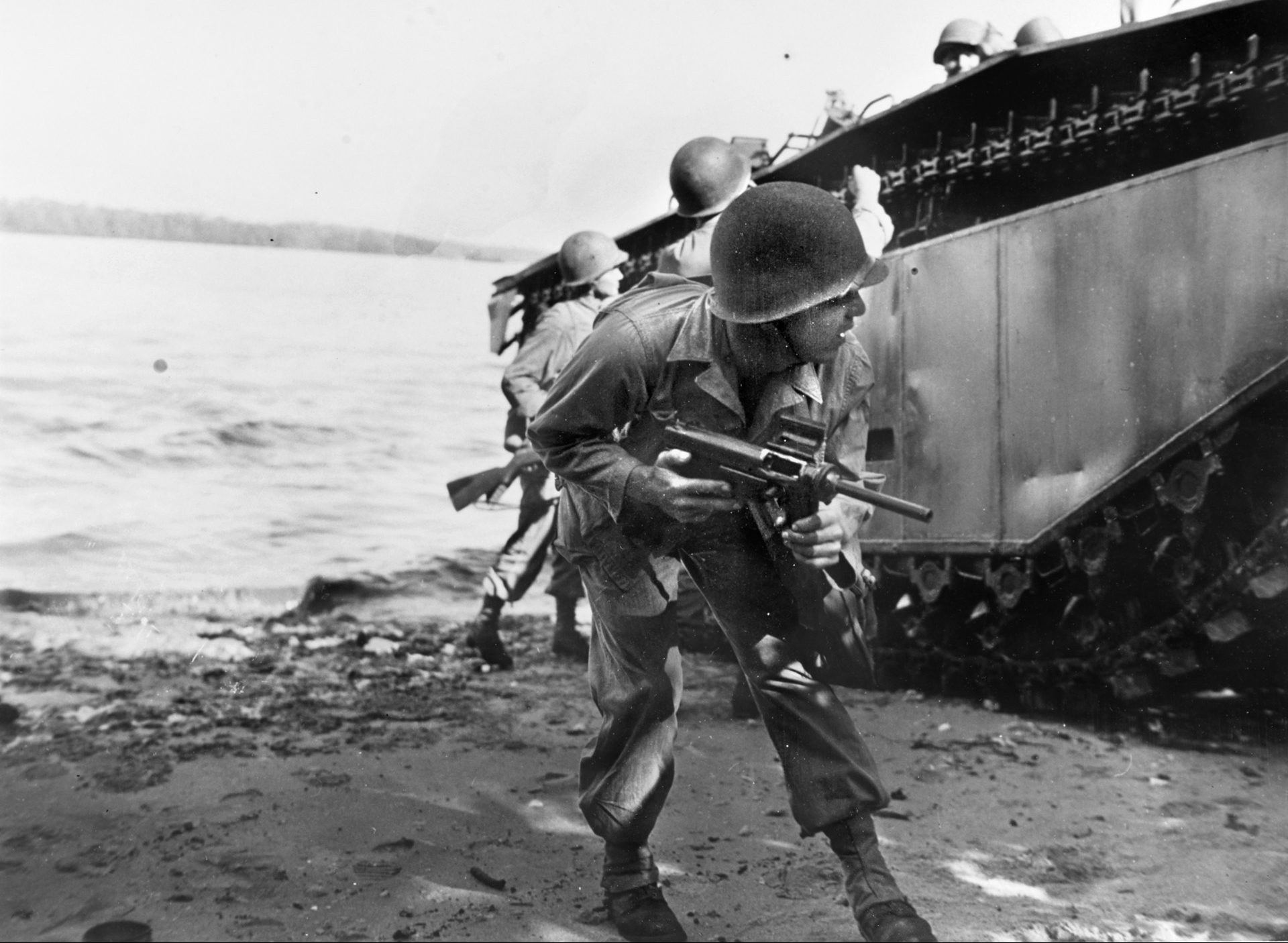An American soldier of the 31st Infantry Division carries an M3 submachine gun, known as the Grease Gun, during landings on the island of Morotai in the Pacific in September 1944.