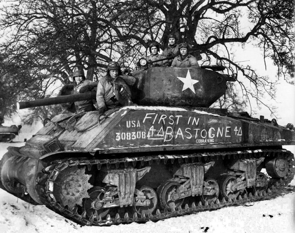 The first tank to reach Bastogne was Cobra King, commanded by Lt. Charles Boggess of C Company, 37th Tank Battalion. Cobra King was a “jumbo” Sherman, an assault tank with six inches of armor on the turret and added armor on the hull. 