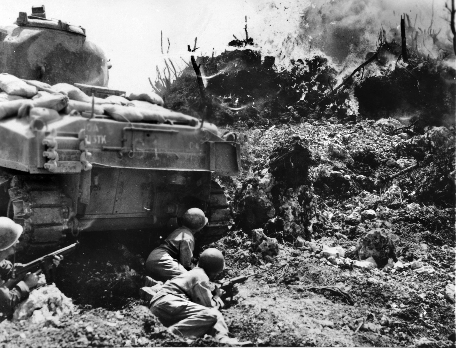 A flamethrowing Sherman tank of the U.S. Army’s 713th Tank Battalion provides cover for advancing infantrymen on Okinawa. The Japanese defenders had fortified the island with three concentric lines of defense and fought grimly to exact a heavy toll in American lives. 