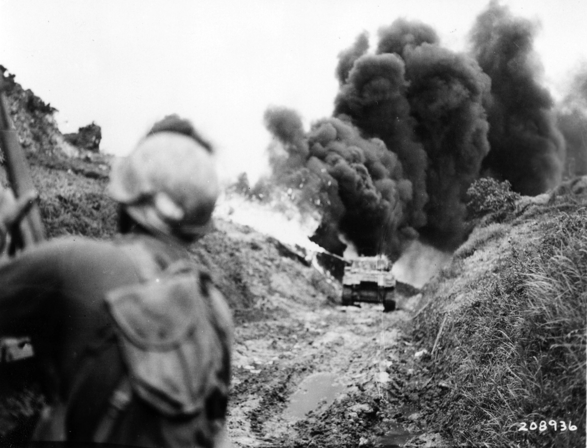 An M4 Sherman medium tank mounting a flamethrower and attached to the 96th Infantry Division spews fire at a Japanese emplacement on Okinawa.