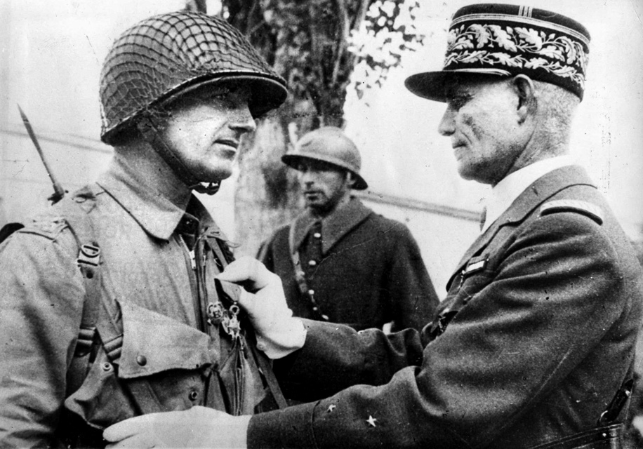 Colonel Edson D. Raff receives the Legion of Honor from French General Edouard Welvert. Raff led the first U.S. airborne troops during operations in North Africa and handled the job well, although he gained a reputation as a somewhat difficult subordinate.