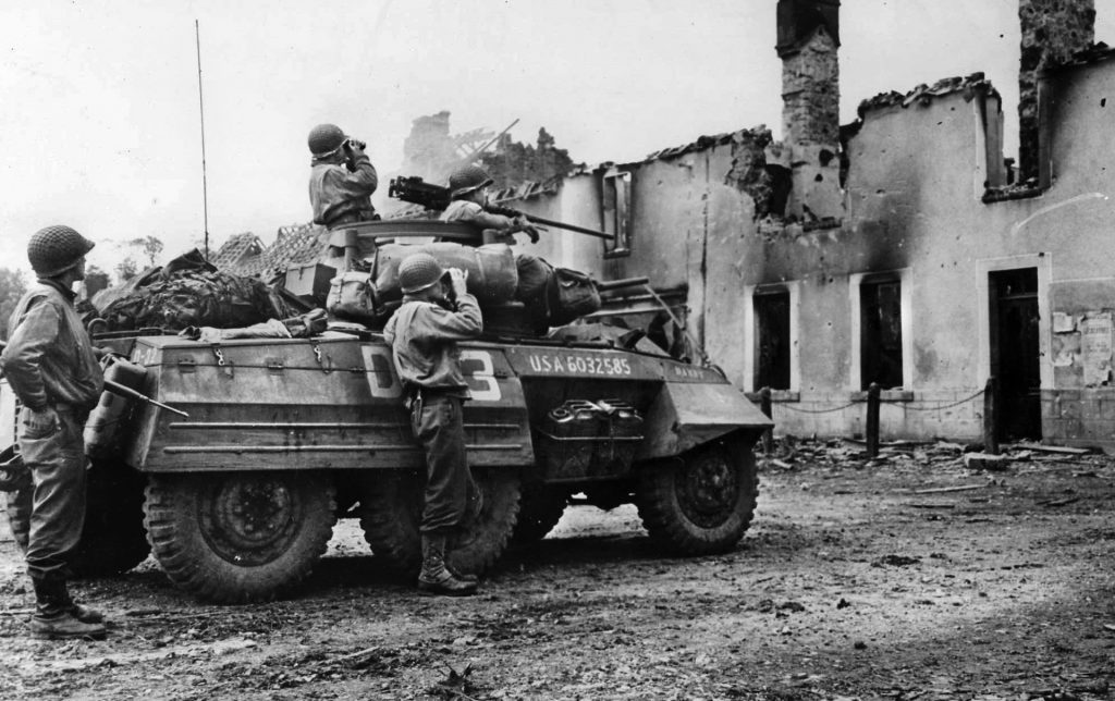 The crew of an M8 armored car pauses to search the Norman countryside for signs of enemy activity. Colonel Raff’s force included a pair of M8s and four jeeps of the 4th Cavalry Reconnaissance Squadron. 