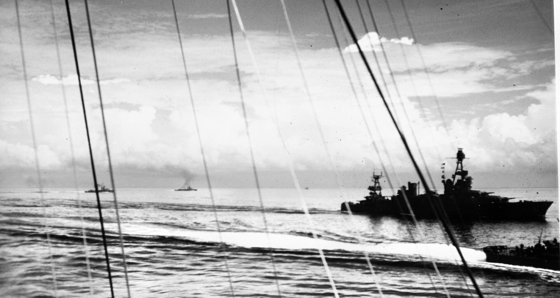 On August 9, following the Battle of Savo Island, a U.S. Navy photographer on USS Ellet captured this image of the cruiser USS Chicago at right, off Tulagi. The stern of an accompanying destroyer is also visible adjacent to Chicago, and other American ships are seen in the distance. 