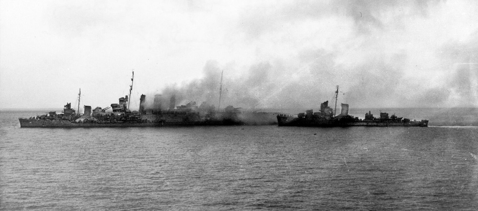  On the morning of August 9, the destroyers USS Blue and USS Patterson maneuver close to the stricken cruiser HMAS Canberra to remove crewmen from the doomed vessel. Soon after, the destroyer USS Ellet was ordered to fire torpedoes into the hulk of the Australian cruiser to sink it. 