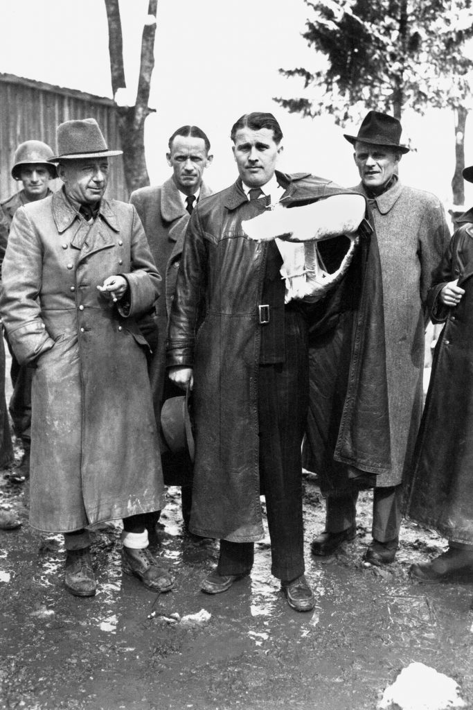Dr. Werner von Braun, standing at center with his arm in a cast following an automobile accident, is pictured with associates following their capture in Austria in 1945.  Von Braun’s group was brought to Fort Hunt under the auspices of Project Paperclip.