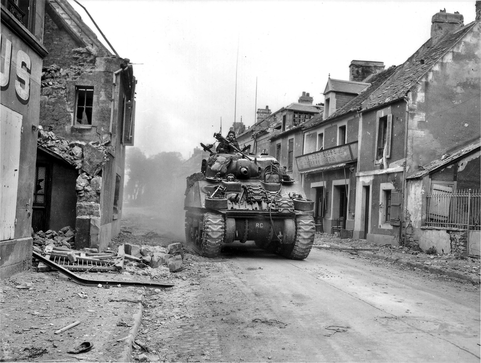 A Sherman tank belonging to the Sherbrooke Fusiliers Regiment rolls through the abandoned streets of Caen on July 10, while the Germans still controlled the southern half of the city. 