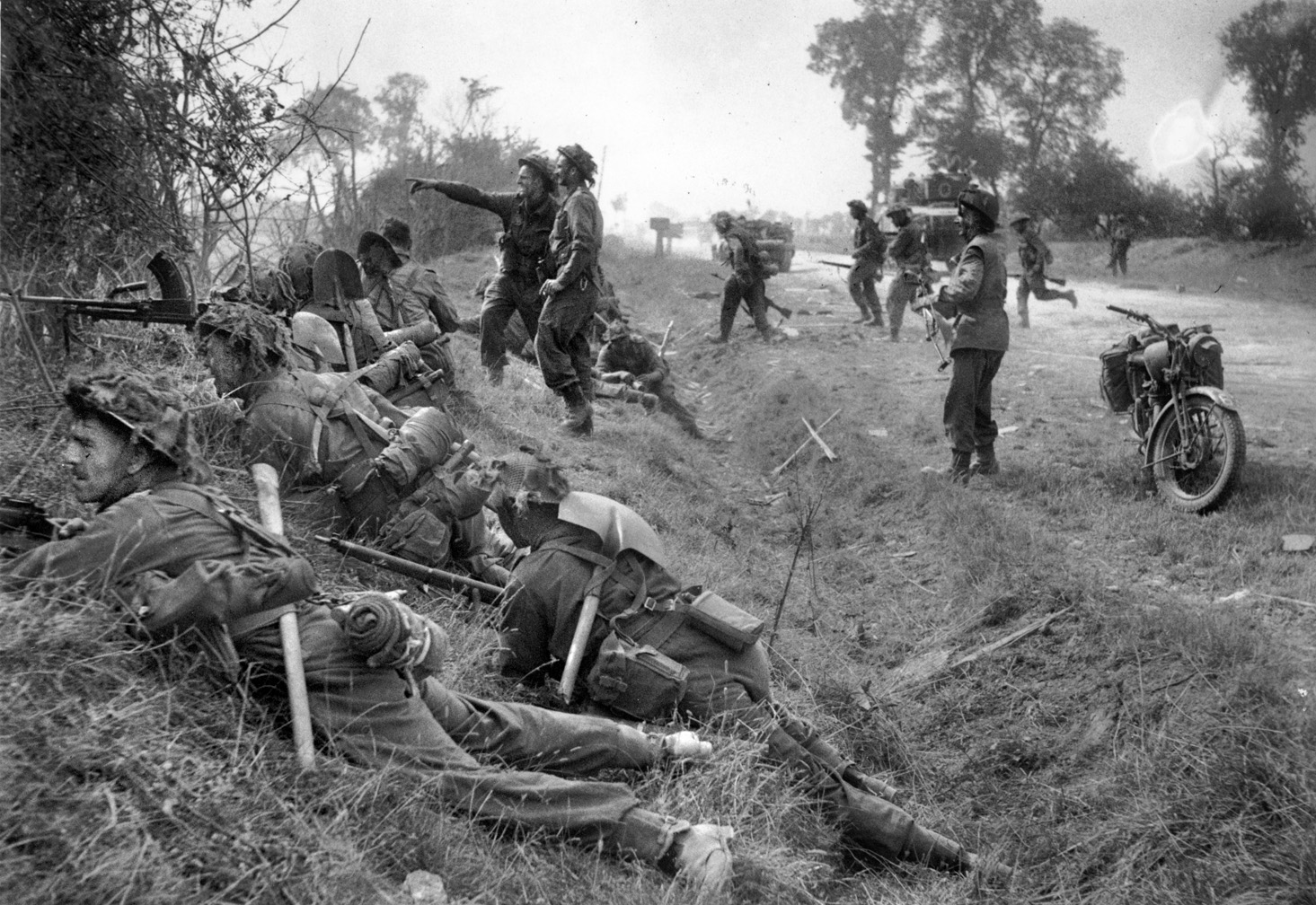 British infantry of the 1st Welsh Guards take cover behind a Norman hedgerow during Operation Goodwood. The bocage, a patchwork of field and woodlands, heavily favored the defending Germans.