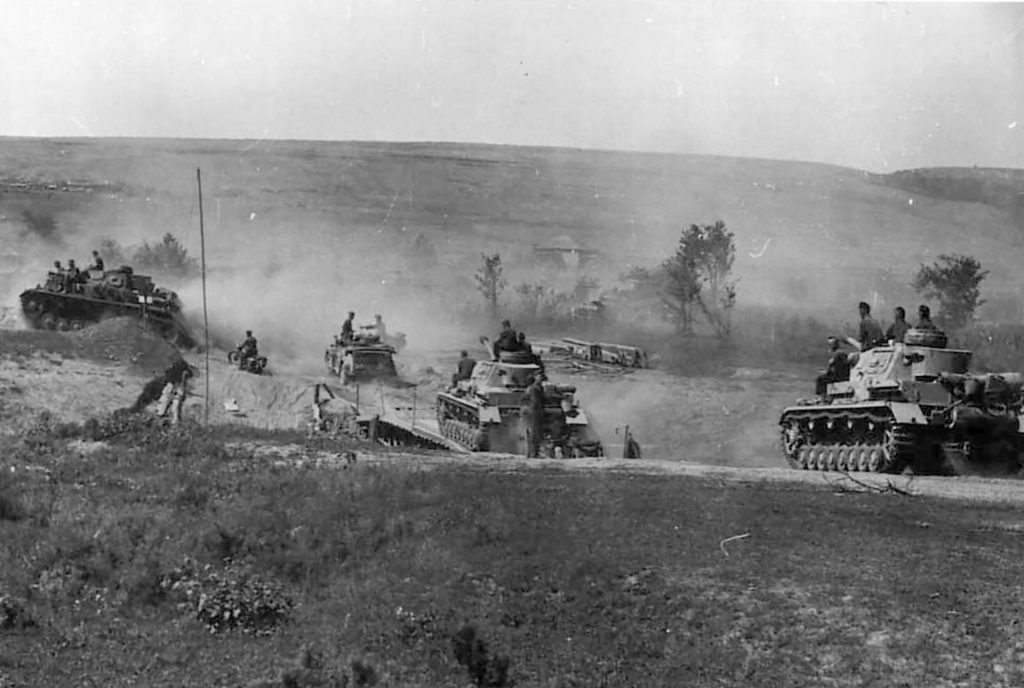 German tanks advance steadily along a dirt road during the opening days of Operation Barbarossa. Early successes contributed to a German sense of overconfidence that was later dashed as the Red Army strengthened.