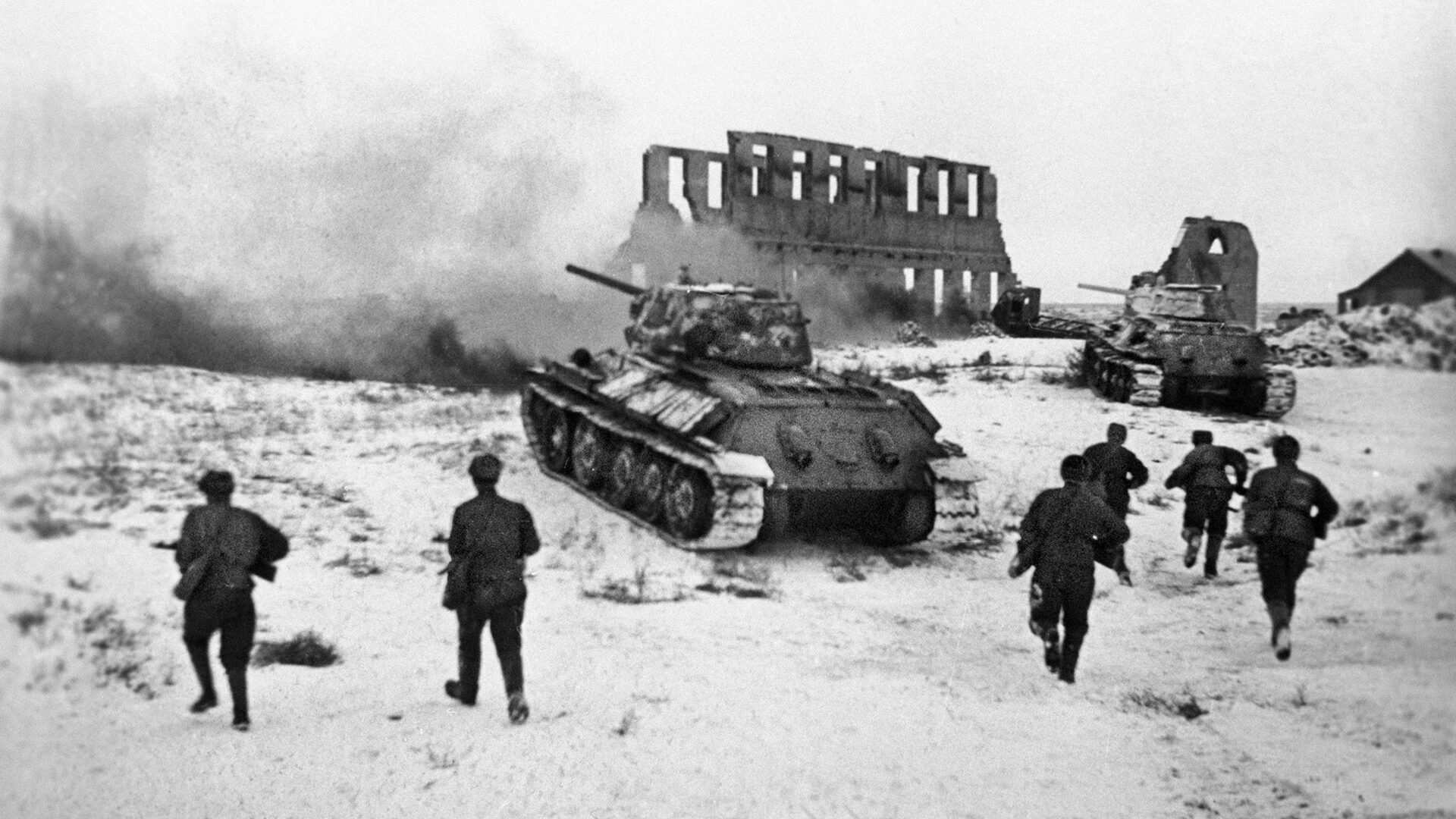Russian soldiers advance across a snow-covered and war-torn landscape as they support T-34 medium tanks during winter operations against the invading Germans. The T-34, perhaps the best all-around tank of World War II, helped turn the tide on the Eastern Front.