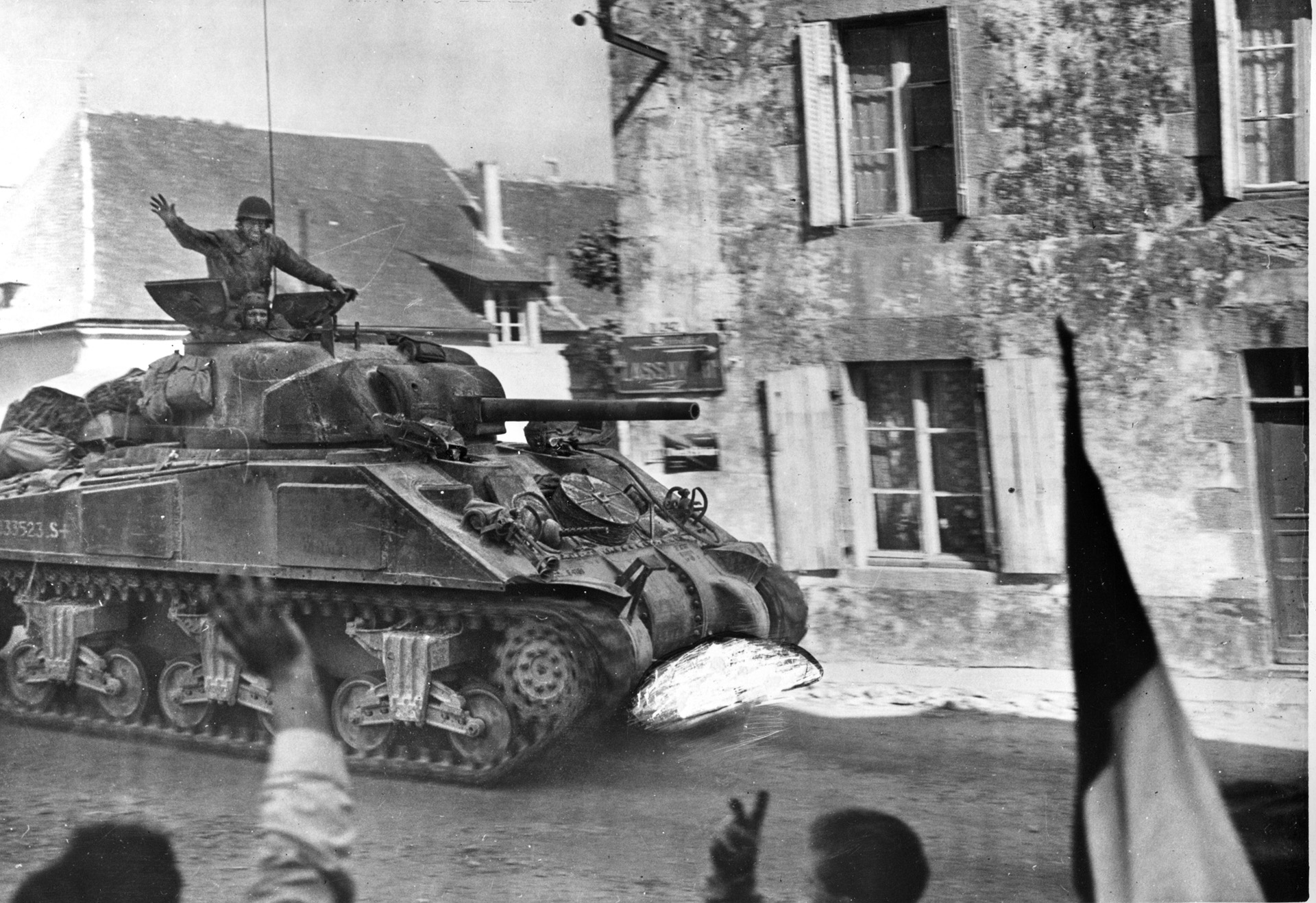 An M4 Sherman medium tank advances through a French village. The Shermans of the 712th Tank Battalion supported the 90th Infantry Division at Mairy. 