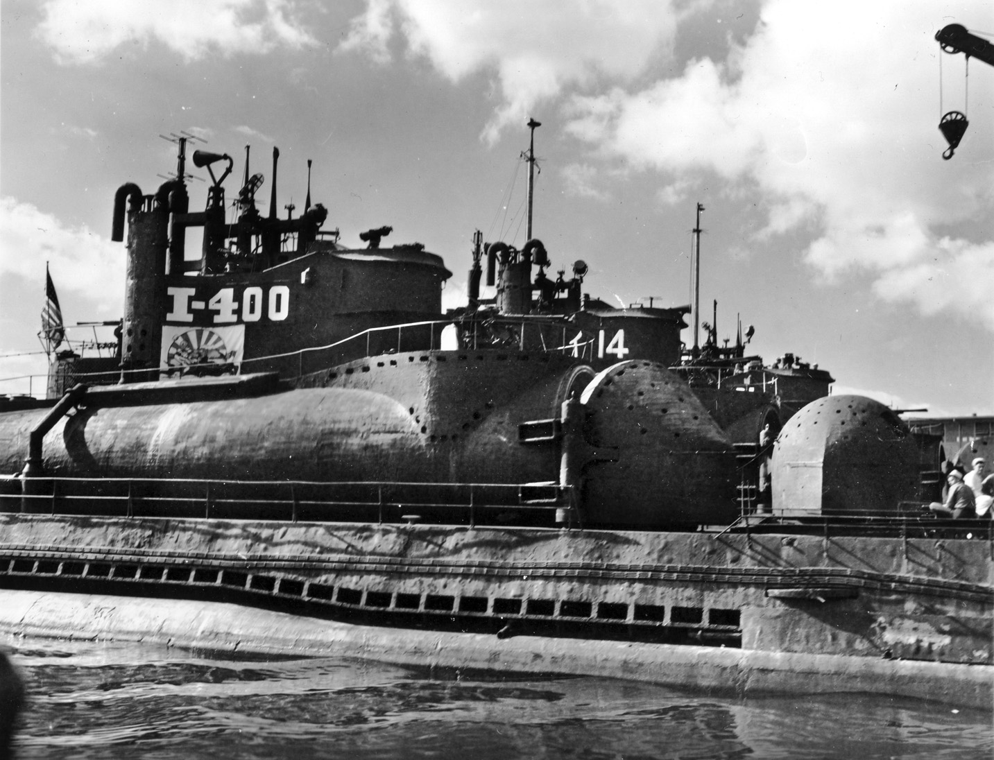 The large Japanese submarine I-400 was surrendered by the Imperial Japanese Navy when World War II ended. Shown here in Hawaiian waters, its substantial hangar is visible. Its original mission to transport bombers to attack the U.S. West Coast never materialized as the fortunes of war turned against Japan. 