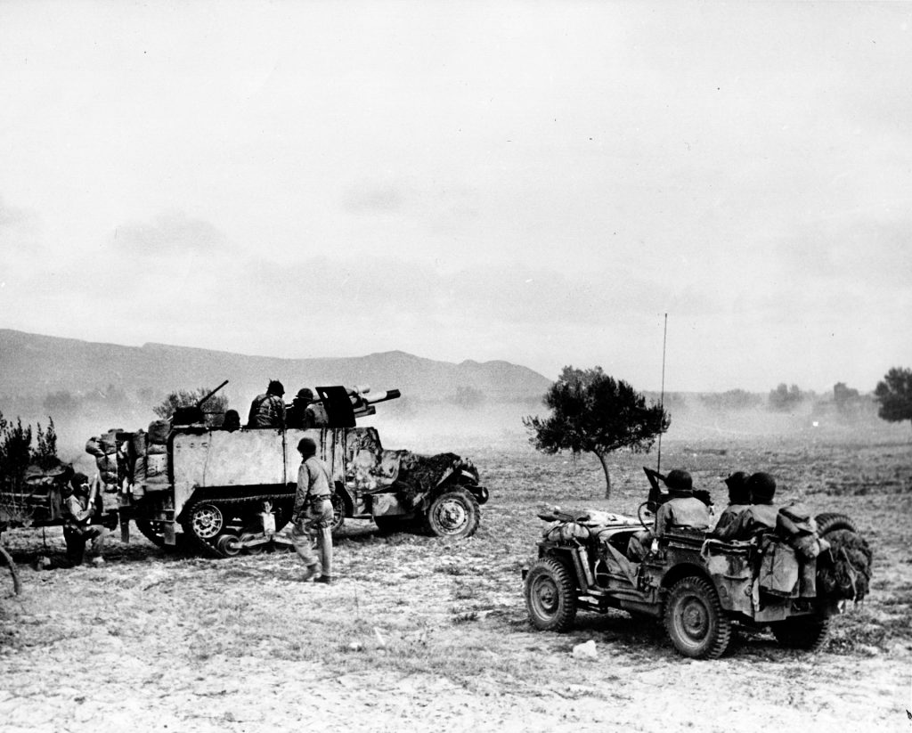 An M3 halftrack tank destroyer is shown in action in the Tunisian desert. Despite their success at El Guettar, Patton questioned their effectiveness after heavy losses.