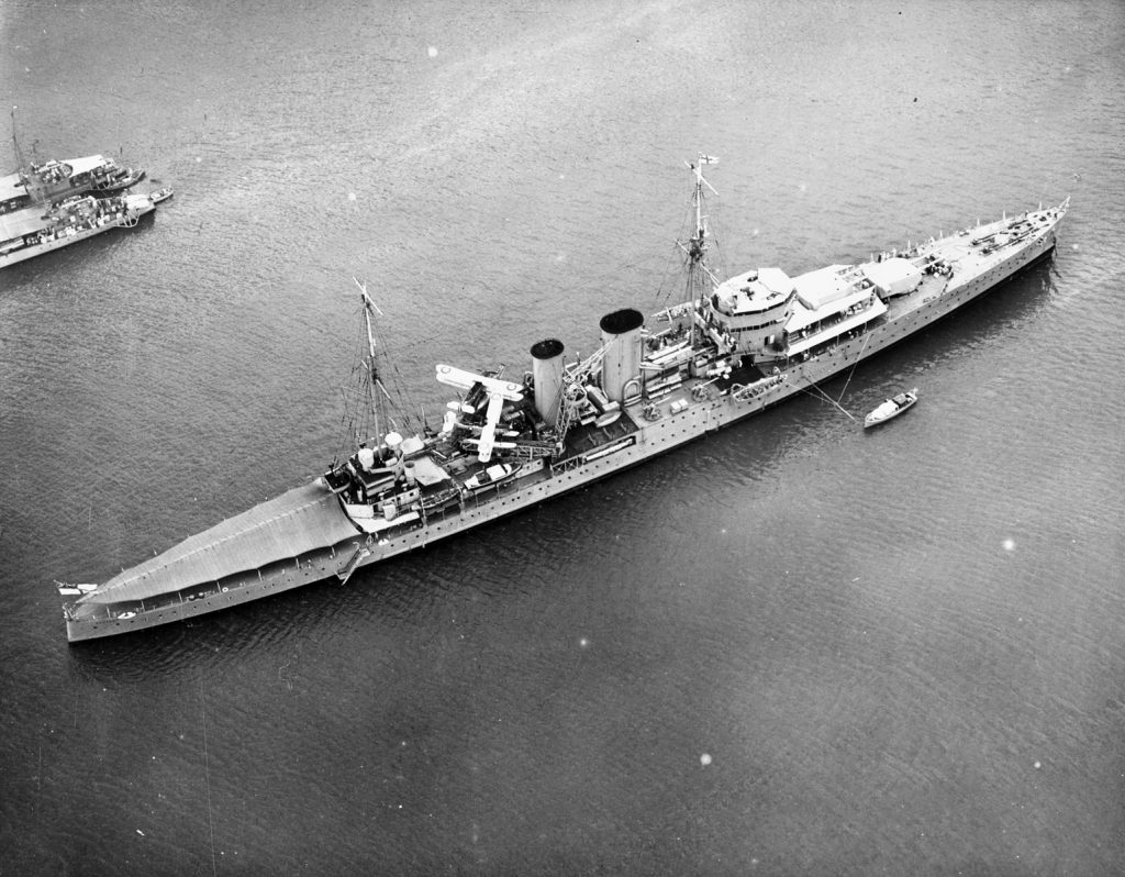 The heavy cruiser HMS Exeter, mounting 8-inch main batteries, lies at anchor in Balboa Harbor off San Diego, California, in 1934. Exeter was the largest of the three cruisers that faced Graf Spee during the Battle of the River Plate.