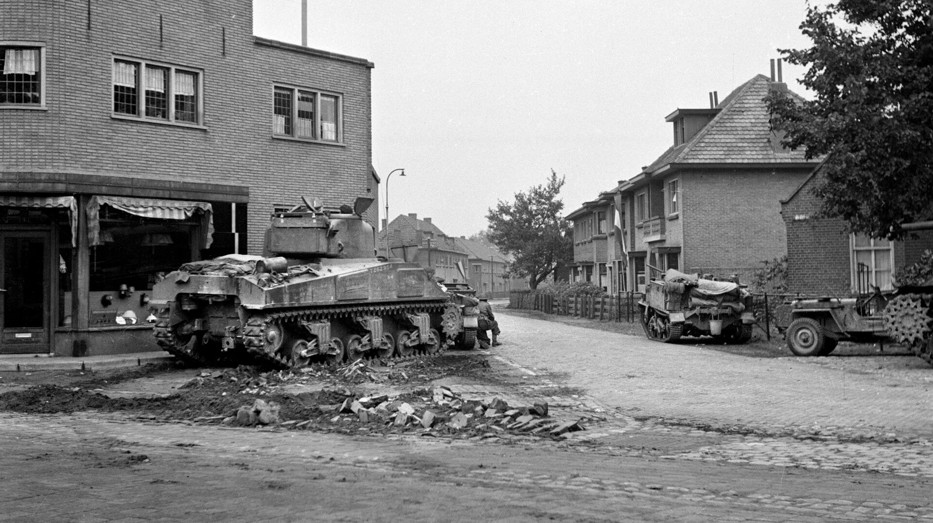 A Sherman tank and Bren Gun carrier of the Irish Guards sit poised for action in the Dutch village of Aaalst, west of Nijmegen. Tanks of XXX Corps brought much-needed firepower and mobility to support the lightly armed troopers of the 82nd Airborne. 