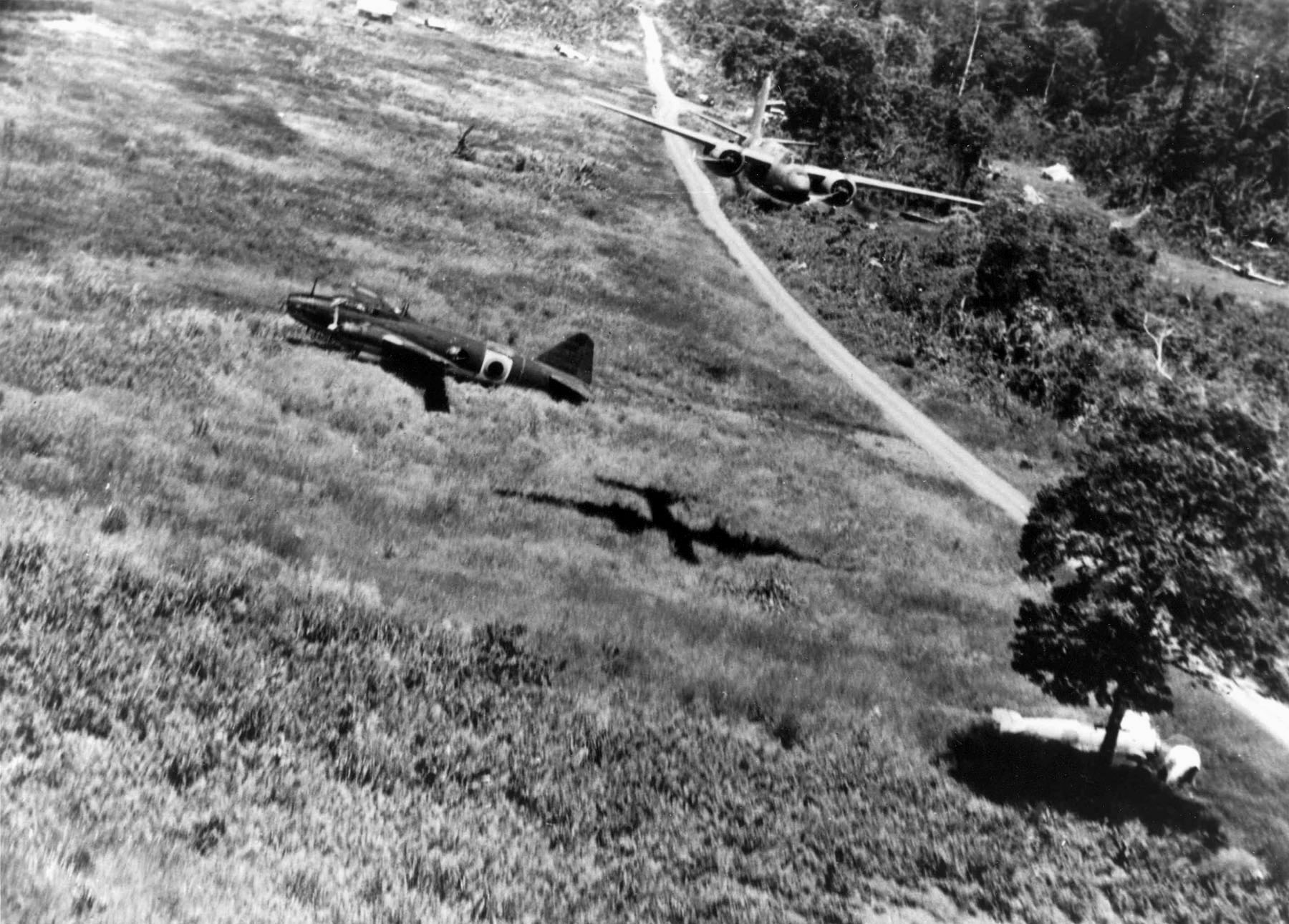 Attacking the Japanese airfield at Lae, New Guinea, this Douglas A-20 Havoc bomber flies low over enemy aircraft parked in the open.