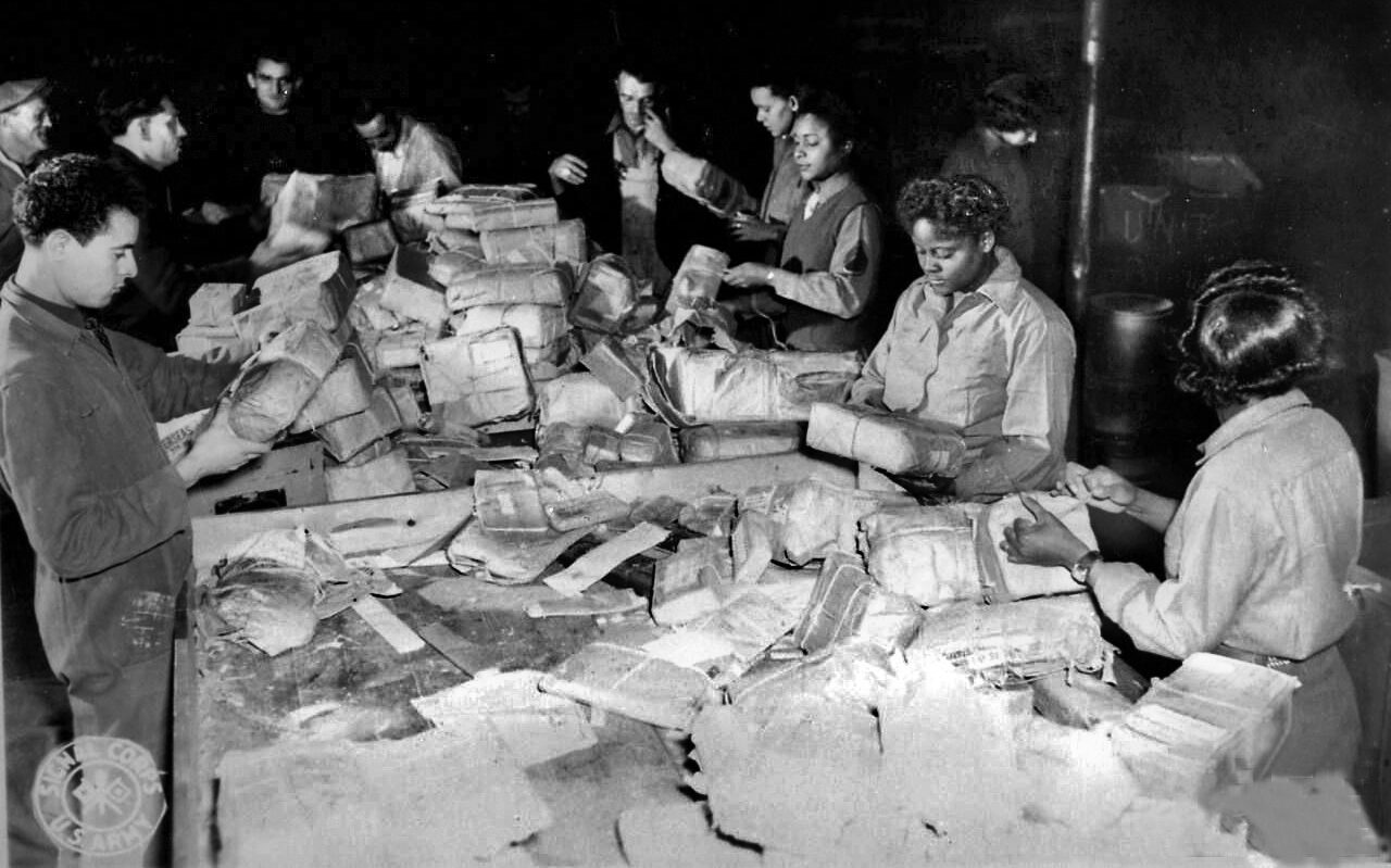 The women of the 6888th sort packages in Rouen, France. 
