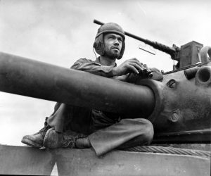 Private Kenneth Boyer, a tank gunner in the 37th Tank Battalion, sits atop his M4 Sherman northeast of Arracourt, France on September 26, 1944. The fighting around Rechicourt began that night.