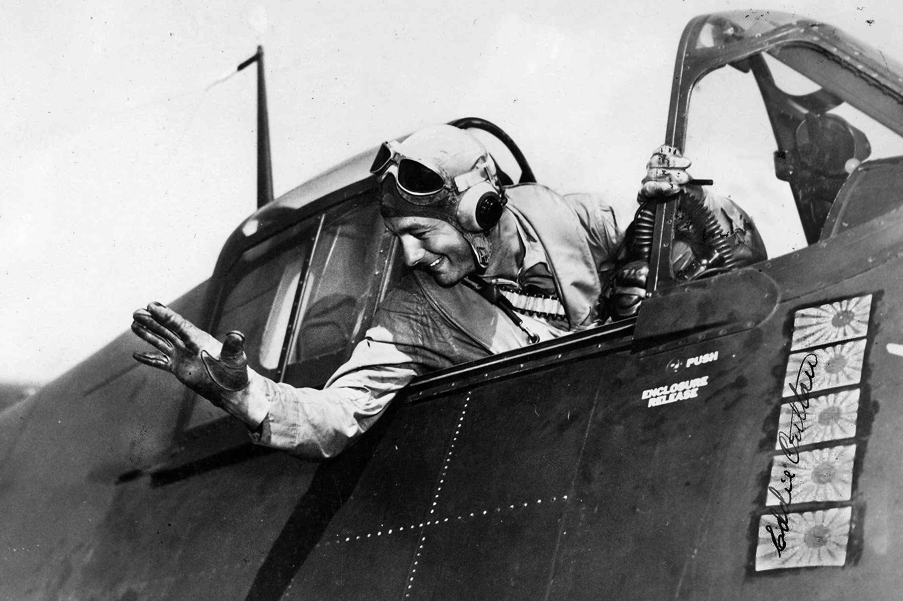 Lieutenant Commander Eddie Outlaw waves to crewmen on the deck of the aircraft carrier USS Langley sometime after the April 1944 raid on Truk Lagoon.