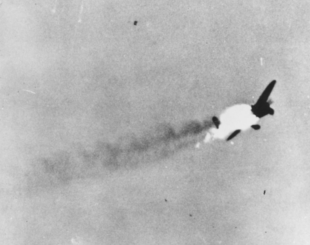 A Japanese Nakajima B6N ‘Jill’ bomber bursts into flames above Truk Atoll during a follow-up fighter sweep on April 30, 1944. 