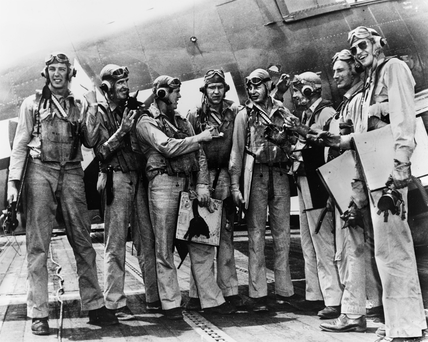 USS Langley’s VF-32 fighter pilots hold up their fingers to indicate victories after their aerial combat over Truk. Hollis Hills stands third from left, Lieutenant Commander Eddie Outlaw stands third from right, while his wingman, Lieutenant (j.g.) Donald ‘Dagwood’ Reeves is fourth from right.
