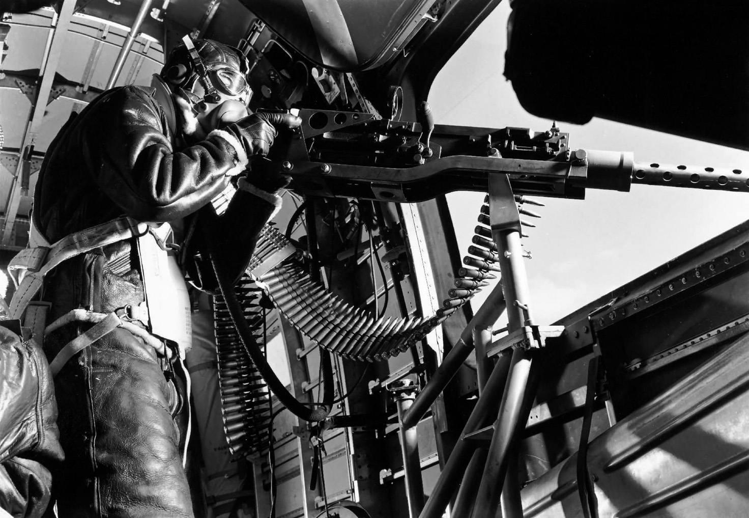 A waist gunner peers from the fuselage of a B-24 heavy bomber. Howard Linn was a waist gunner and an assistant engineer, as it was common for airmen to be proficient at more than one job aboard a bomber. 