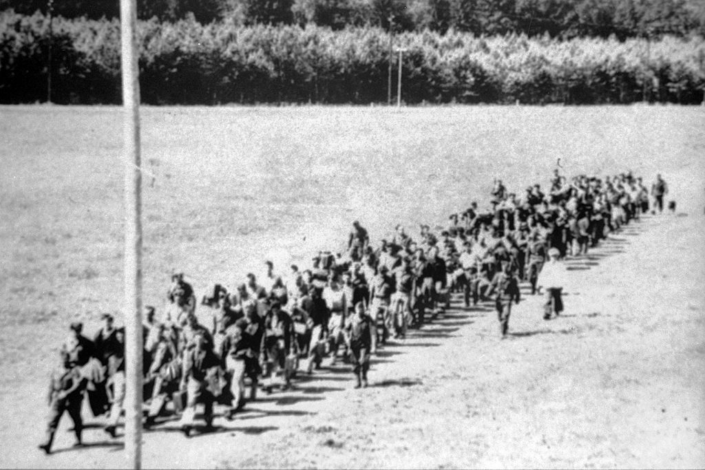 German guards march prisoners of war to their barracks at Stalag Luft IV, where Howard Linn was held by the Nazis after his plane had been shot down.  