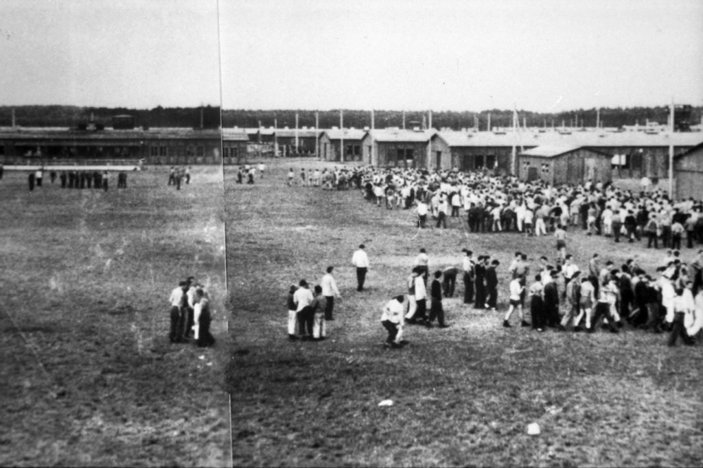 Prisoners gather outside their barracks at Stalag Luft IV. Prisoners were required to stand in formation twice a day to be counted, and guards constantly roamed the grounds. 